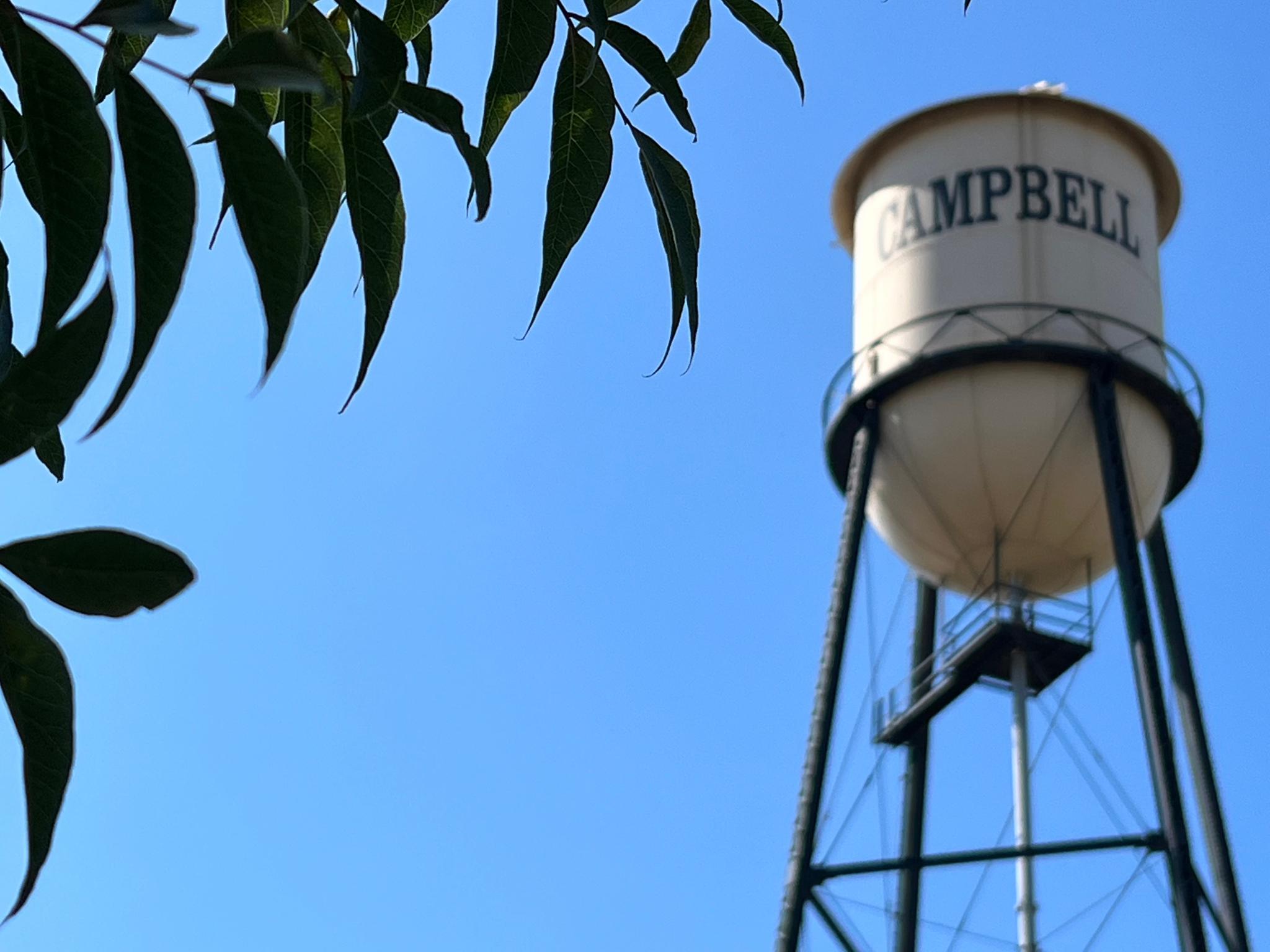 clear sky, white text, water tower