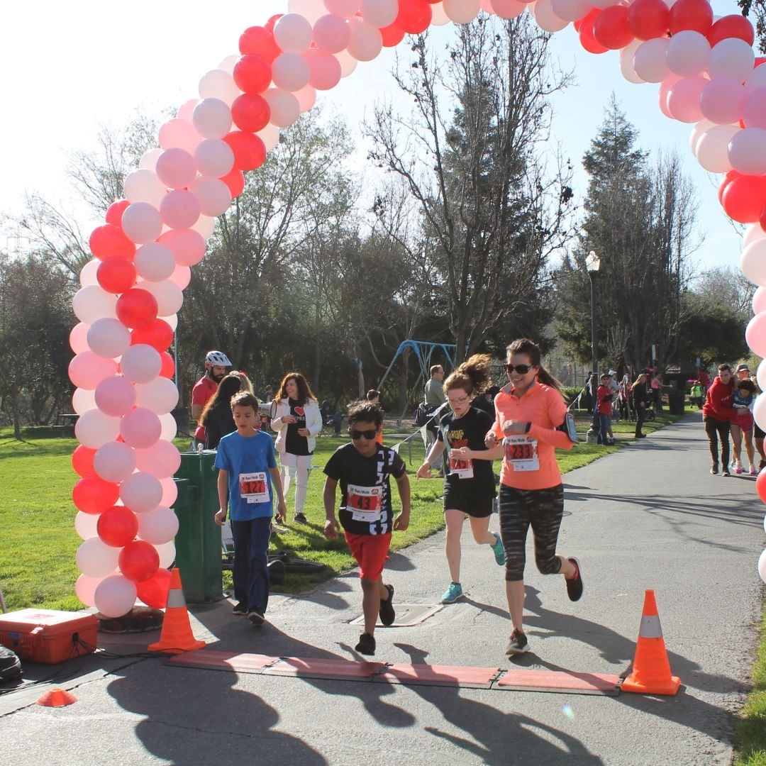 two Runners crossing finish line at the Valentine Fun Run